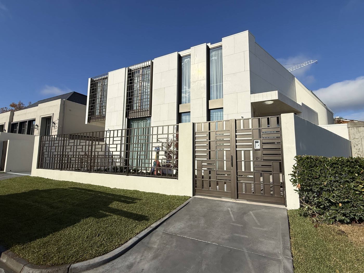 The finished $10M Toorak home, an architect-designed house in pale stone.