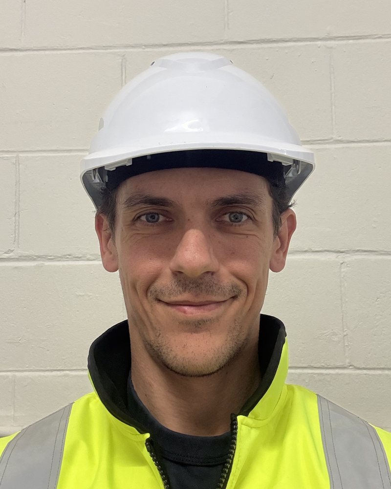 Milé Neckoski in a hard hat and hi-vis vest.